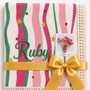 Summer Waves muslin blanket with pink and green wavy stripes, Ruby embroidered in green, cream fringe and yellow ribbon.