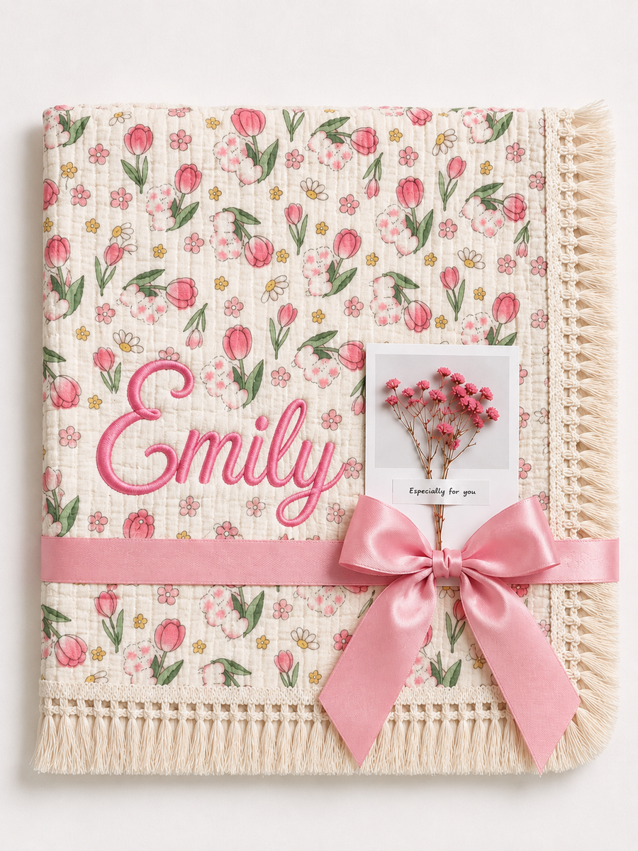 Tulip Burst muslin baby blanket with pink tulip print, Emily embroidered in pink, cream fringe and pink ribbon.